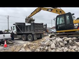 Busting up concrete for a parking lot .