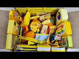 Box full of amazing yellow stationery items, pencil case, matchbox eraser, spongeBob toy, pencils