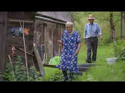 Happy old age of an elderly couple in a mountain village in the summer far from civilization