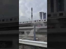 Construction crane falls into moving train