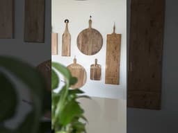 Turn your kitchen wall into a stylish display with hanging serving boards! 🖤✨