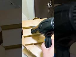 Person Removes Sticker From Wood Using Blow Dryer