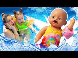 The baby doll needs help! Maya and her mom pretend to play lifeguards at the swimming pool.