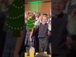 Choir singer lights up when he sees his parents during a Christmas performance.