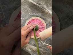 Pressing this pink flower into the clay to capture its delicate details 🌸 #flowers #clay #handbuild