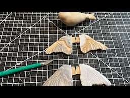 Wood carving open wings for a goldfinch