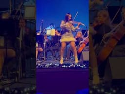 This Latina can play. Violin player and orchestra