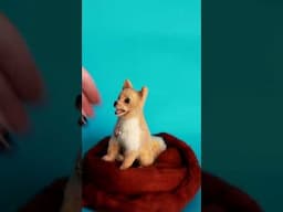 Needle felted Pomeranian dog sculpture.