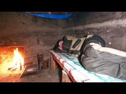 Building of a warm and secret dugout in the wild forest, forest shelter