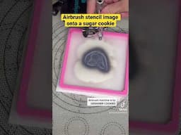 Airbrush stencil image onto a sugar cookie