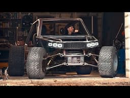 A man is building a unique all-terrain vehicle in a garage!